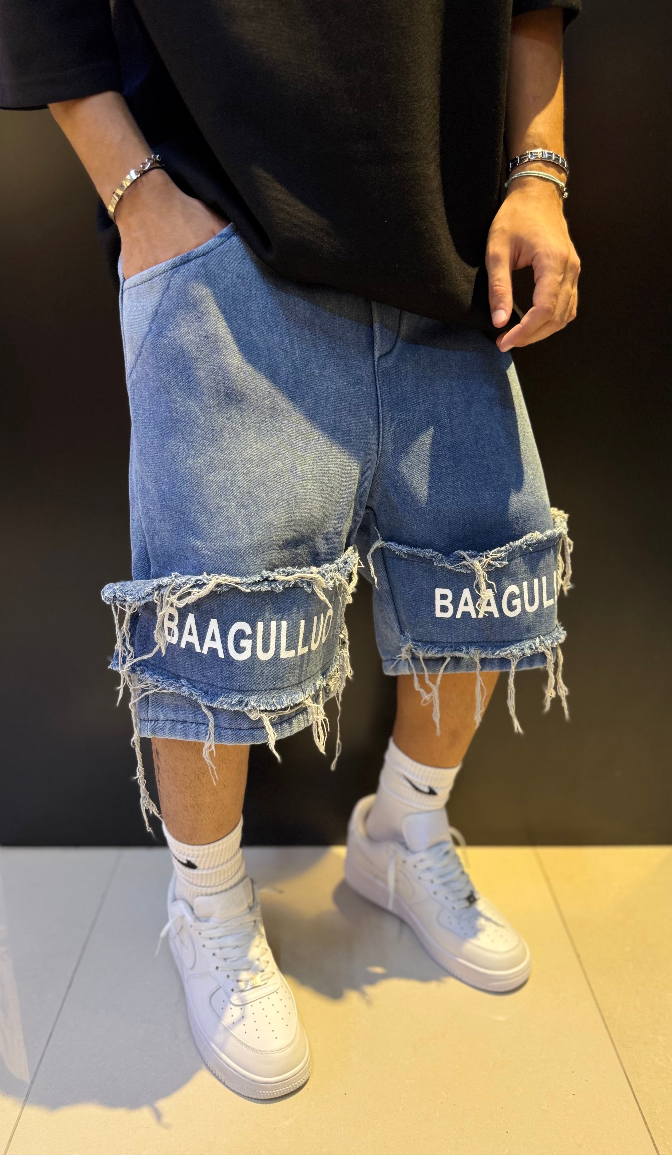 Blue Denim Shorts with Frayed Hems and "BAAGULLUO" Text